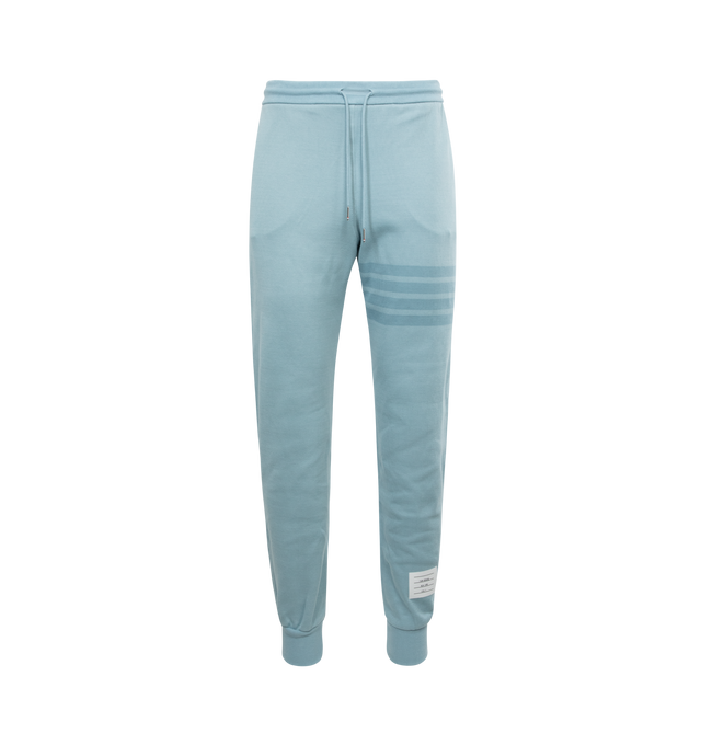 Image 1 of 3 - BLUE - THOM BROWNE Double Face Knit Tonal 4-bar Sweatpants featuring drawstring waistband with silver tone aglets, 4-bar detailing, slip side pockets, name tag applique above left hem, button cuffs with signature grosgrain trim and signature striped grosgrain loop tab. 100% cotton. 