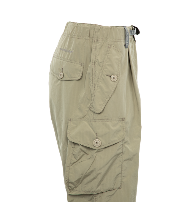 Image 3 of 3 - GREEN - AND WANDER 81 Oversized Cargo Pants featuring ripstop texture, straight leg, elasticated waistband, dart detailing, two side button-fastening pockets, two side cargo pockets, two rear button-fastening pockets, embroidered logo to the rear, tied cuffs and front button and zip fastening. 67% polyester, 33% nylon. 