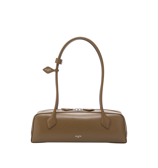 Image 1 of 1 - BROWN - Alaia Le Teckel Boston bag with elongated shape featuring long handles signed and held together by 2 decorative fasteners. Features double zip closure, includes a small mirror. Shoulder carry. Main Material: Leather. Dimensions (cm): l 33 x h 11 x d 10. Made in Italy.