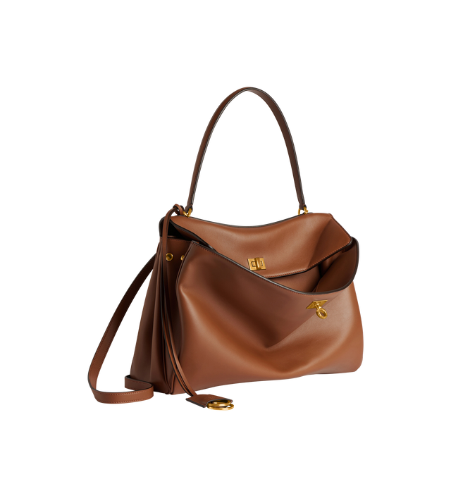 Image 2 of 5 - BROWN - BALENCIAGA Rodeo Top Handle Bag featuring a turn lock closure, a single top handle for hand carrying, an adjustable shoulder strap, side snaps, brass feet, a removable leather keychain holder, a wide front pocket and an interior zipper pocket. 13.8 X 9.2 X 4.3 inches. 100% calfskin. Made in Italy.