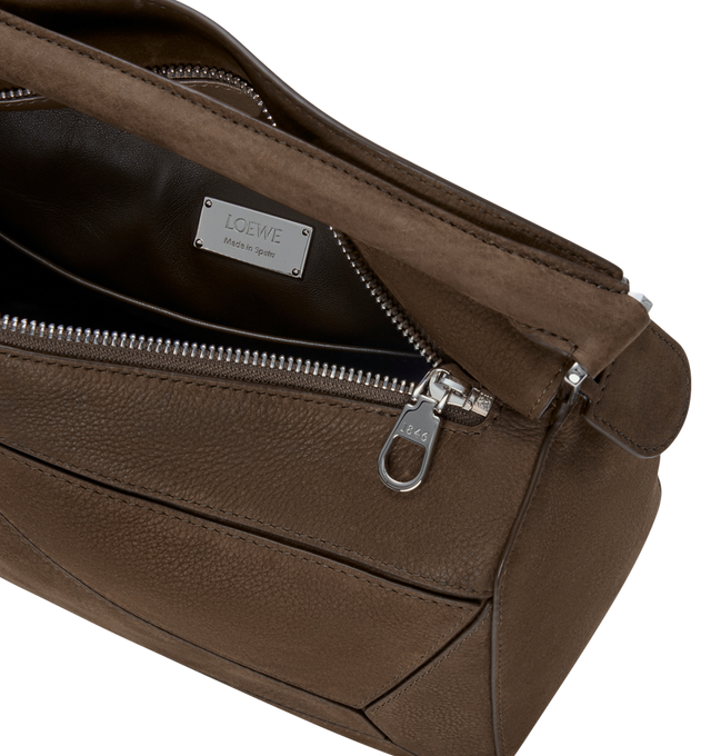 Image 4 of 5 - BROWN - LOEWE Small Featherlight Puzzle bag in grained nubuck featuring distinctive geometric lines and cuboid form, shoulder, crossbody or hand carry, detachable and adjustable strap with rotating dogclips, zip closure with articulated pull, one external zipped rear pocket, one internal slip pocket, detachable LOEWE embossed tag with secret pocket and balloon dice, baguette-shaped metal feet, nappa lambskin lining and embossed Anagram, LOEWE engraved internal plaque. Grained nubuck. 16.5 cm