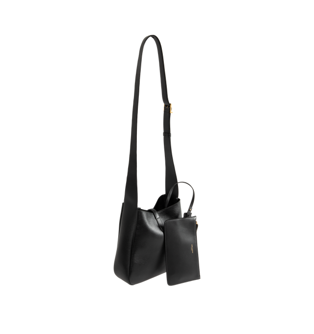Image 2 of 3 - BLACK - Saint Laurent Womens Le 5 7 Crossbody Bag is crafted from grained calfskin leather. Features an adjustable crossbody strap, CASSANDRE hook closure, removable zip pouch, suede lining, and bronze-tone hardware. Dimensions: 22.5 23 8.5 cm; Strap Drop: 50 cm. Main Material: Calfskin Leather; Lining: Suede; Hardware: Brass. Made in Italy.