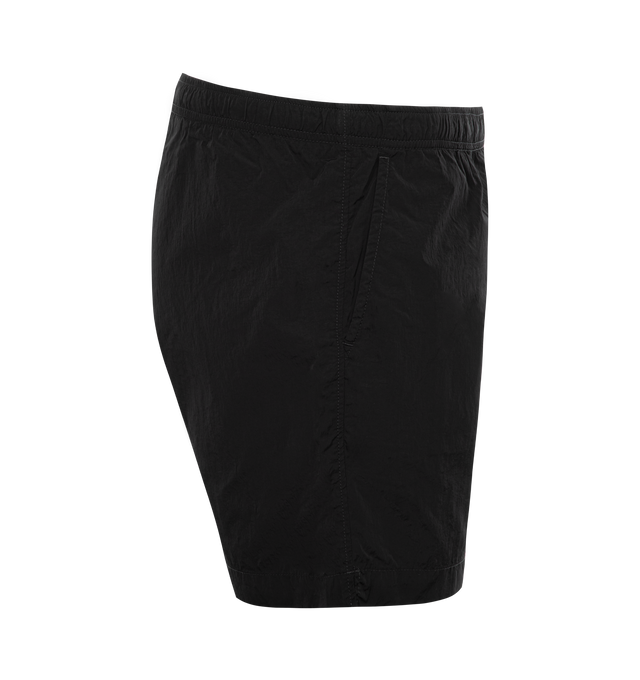 Image 3 of 3 - BLACK - C.P. COMPANY Eco-Chrome R Swim Shorts featuring tonal stitching, two side slash pockets, logo patch to the leg, short side slits, thigh-length, mesh lining and elasticated waistband with internal drawstring. 100% polyamide. 