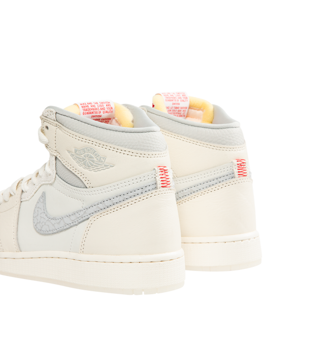 Image 3 of 5 - WHITE - NIKE Air Jordan 1 Retro High OG Sneaker featuring premium leather, elephant print on the Swoosh logo, lace up closure, translucent outsole, exposed foam in the tongue and red contrast stitching on the heel.