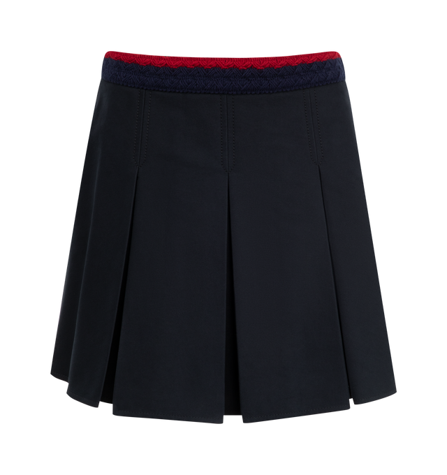 Image 1 of 4 - NAVY - MONCLER Pleated Mini Skirt featuring stretch cotton gabardine, striped braided waistband, side zipper closure and pleated. 98% cotton, 2% elastane/spandex.