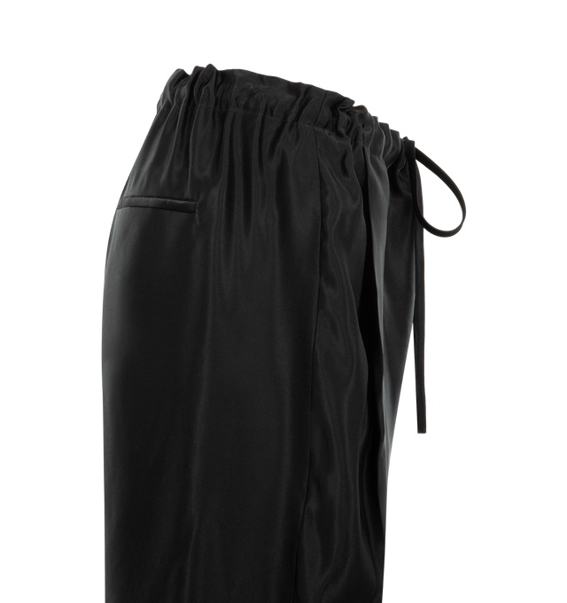 Image 3 of 3 - BLACK - KHAITE Rohen Pant featuring a pull-on pant, relaxed, bow-leg silhouette, a concealed pocket and a herringbone grosgrain tie at the elasticated waist. 59% viscose, 41% cupro.