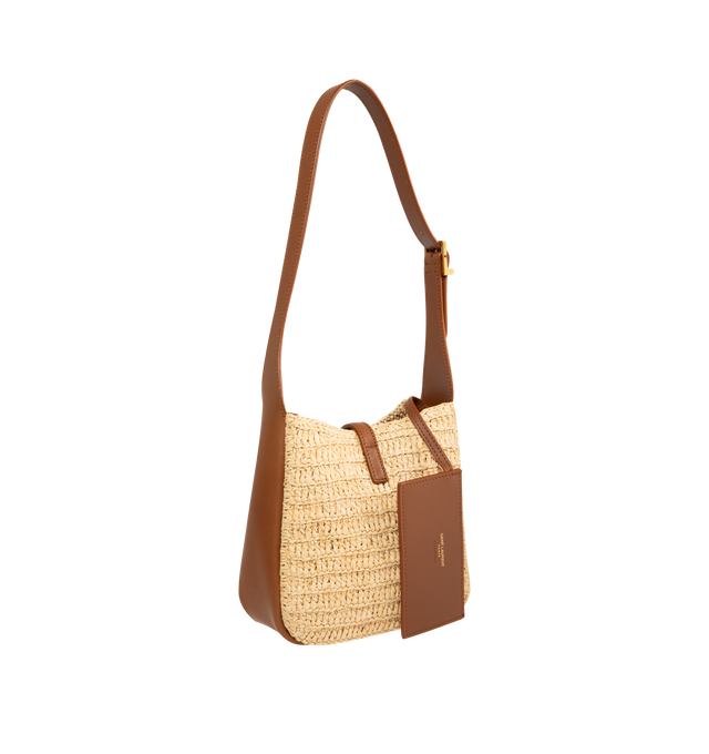 Image 2 of 3 - BROWN - SAINT LAURENT LE 5 7 Supple Baby in raffia and vegetable-tanned leather featuring an inner card holder, leather tab closure decorated with the CASSANDRE, an adjustable strap and bronze-tone hardware. 6.3" x 6.7" x 3". Raffia, calfksin. Made in Italy.