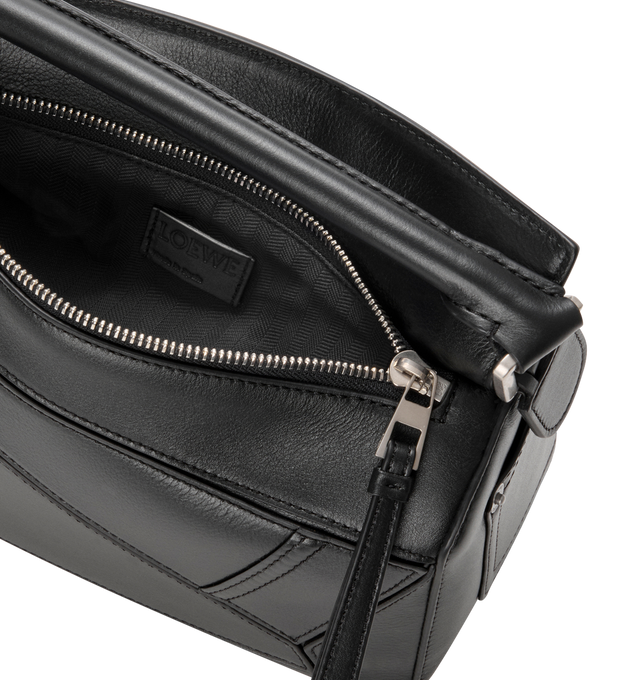 Image 4 of 4 - BLACK - LOEWE Panta Small Puzzle Bag featuring distinctive geometric lines and cuboid form. This small version is crafted in shiny calfskin with denim trousers-inspired details, shoulder, crossbody or hand carry, detachable and adjustable strap, zip closure with calfskin pull, one external rear pocket, one internal slip pocket, herringbone cotton canvas lining and embossed Anagram. Shiny calf. 16.5 cm x 24 cm x 10.5 cm. Made in Spain.