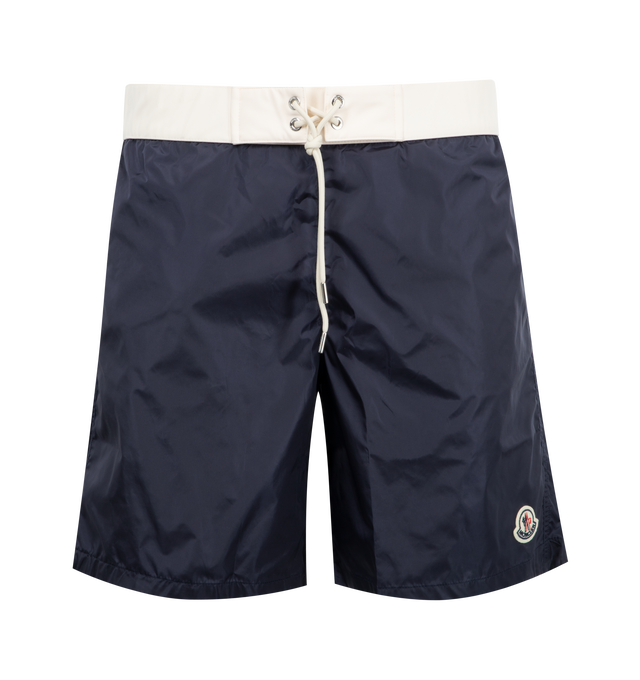 Image 1 of 3 - NAVY - MONCLER Contrast-Band Swim Shorts featuring elasticized drawstring waist, regular rise, side slip pockets, back flap pocket, relaxed legs, logo emblem on left leg and pull-on style. Nylon. Lining: Elastane/nylon.