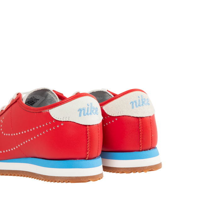 Image 3 of 5 - RED - NIKE Cortez Sneaker featuring leather upper with suede trim and rubber gum sole, lace-up front, embroidered Nike logo on tongue, perforated signature swoosh at sides and embroidered logo at back counter.
