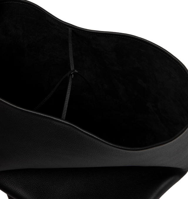 Image 3 of 3 - BLACK - THE ROW Classic tote bag in grained calfskin leather with interior tie closure, flat handle, and custom hook hardware. Measures 15 x 17 x 8 in. 100% Calfskin Leatherlined in suede. Made in Italy.