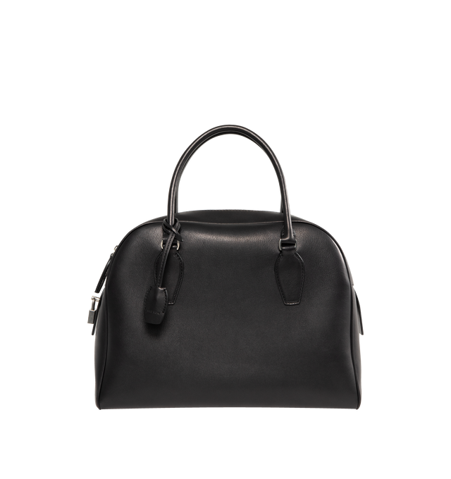 Image 1 of 3 - BLACK - THE ROW India 12.00 Bag in Leather featuring updated bowling bag in polished saddle leather with tubular handles, branded metal padlock and key, and zipper closure. 12 x 9.5 x 12 in. 4.75 in. Handle drop. 100% calfskin leather. Lined in 100% leather. Made in Italy.