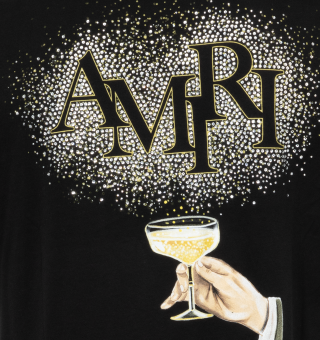 Image 4 of 4 - BLACK - AMIRI CRYSTAL CHAMPAGNE TEE has a bold Amiri logo lettering and a graphic motif on the back in a yellow gold color. This soft style provides an effortless fit, crewneck, short sleeves and pulls over. 100% cotton. 