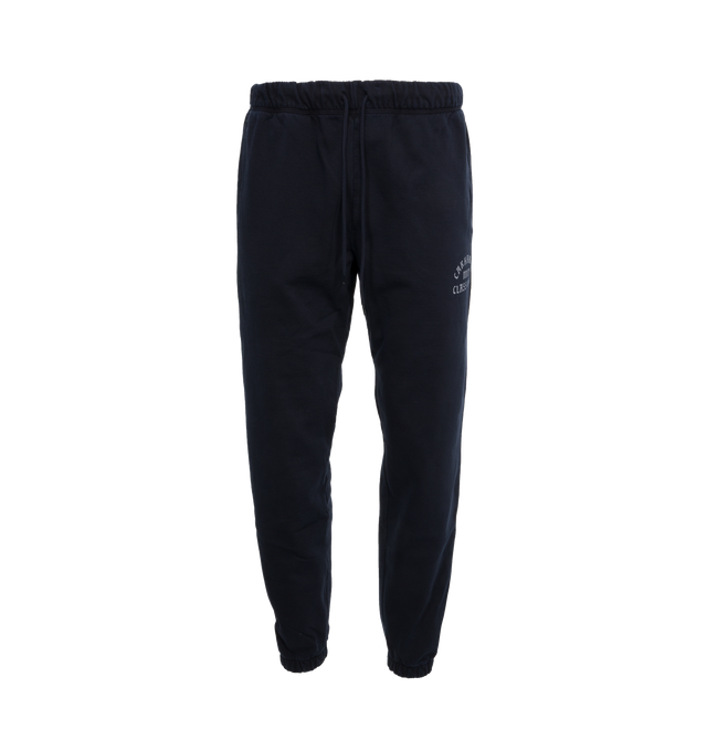 Image 1 of 5 - NAVY - CARHARTT WIP Class of 89 Sweat Pant featuring loose fit, pigment-dyed, adjustable waistband, two side pockets, one rear pocket, graphic print and square Label. 84% cotton, 16% polyester. 