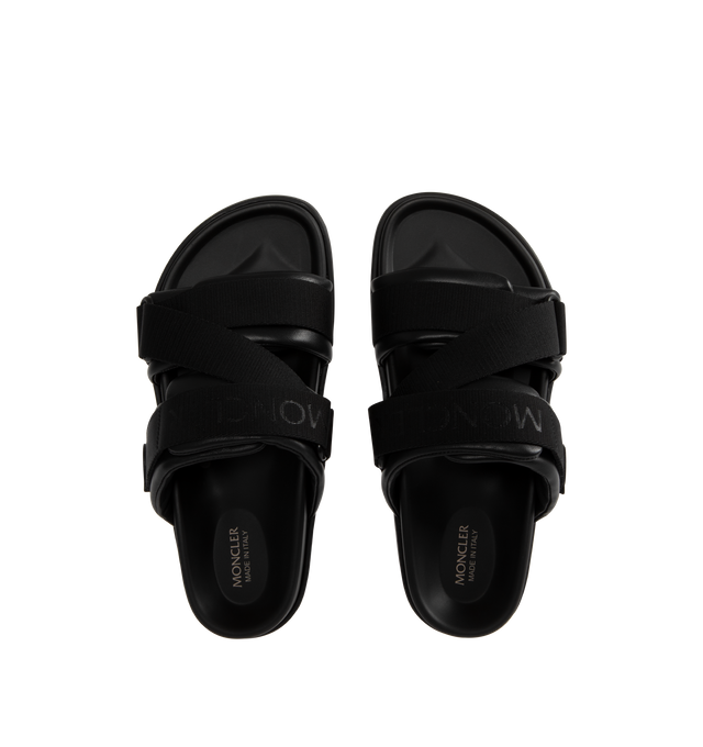 Image 4 of 4 - BLACK - MONCLER Mon Summer Leather Crisscross Sandals featuring crisscross logo-stamped polyester strap, flat heel, dual band upper, slip-on style, molded footbed, rubber outsole. Lining: leather. Made in Italy.