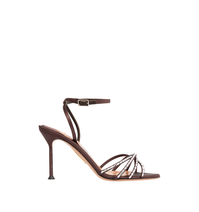 Image 1 of 4 - BROWN - AQUAZZURA Tell Me Crystal Sandal 85 featuring adjustable buckle closure, gemstones that trace the caged design framing the toes, slim stiletto mid heel, padded leather insole and signature logo detailing. Satin. 85mm heel. Made in Italy.