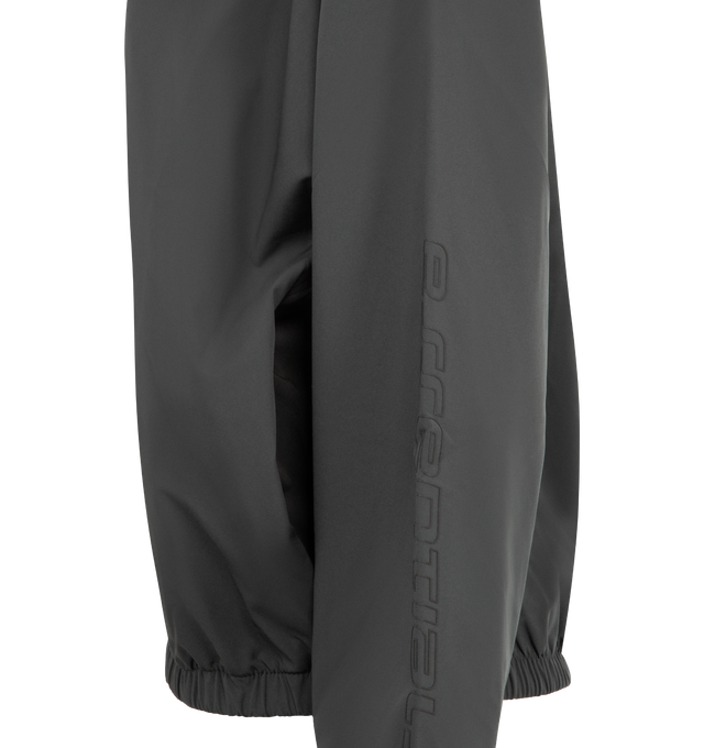 Image 3 of 3 - GREY - FEAR OF GOD ESSENTIALS Nylon Half Zip Track Jacket featuring nylon-spandex, detailed with an metallic 3M-printed Essentials graphic on the sleeves, relaxed, rounded silhouette, high neck, half-zip front, elasticized cuffs and waist hem and a Fear of God Essentials rubberized label stitched at the back. 84% nylon, 16% spandex.