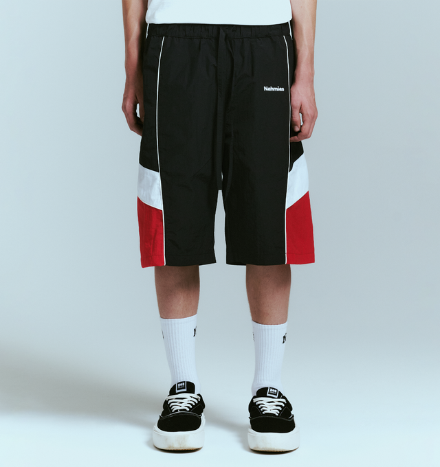 Image 2 of 4 - BLACK - NAHMIAS Warm Up Short featuring ollie wave design, colorblocking, elastic waist with drawstring, embroidered logo, two side pockets and back welt pockets. Nylon.