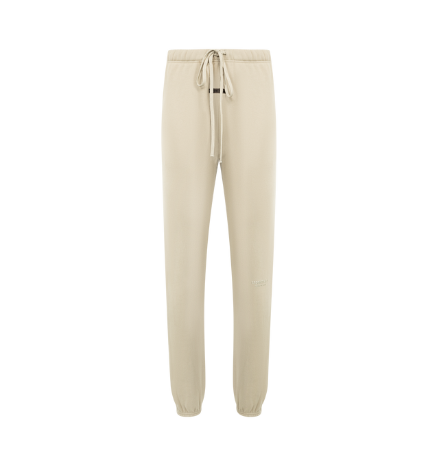 Image 1 of 3 - NEUTRAL - FEAR OF GOD ESSENTIALS Vintage Fleece Sweatpant featuring vintage fit, slimmer leg, "Essentials Fear of God" beveled metallic logo, encased elastic waistband, heavyweight drawstring with rubberized tip, side seam pockets and "Fear of God Essentials" translucent rubberized label. 80% cotton, 20% polyester fleece.