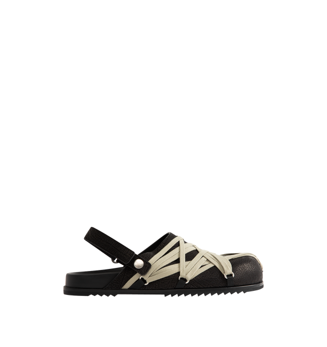 Image 1 of 4 - BLACK - Rick Owens Men's Megalace Granola Mules crafted from medium weight cracked calf leather. Slip-on covered style featuring an open back with adjustable strap, sculpted footbed, sharktooth sole and signature mega-lacing detail in a pentagram shape covering the front. 100% calf leather upper and lining, cow leather sole with rubber detail. Made in Italy.