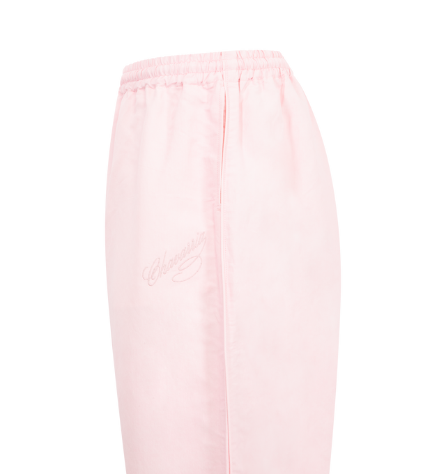 Image 3 of 3 - PINK - WILLY CHAVARRIA Ruff Rider Track Pant featuring a loose fit, an elastic waistband with a hidden drawstring, embroidered script logo on the left and side slit pockets. 50% cotton, 50% linen.
