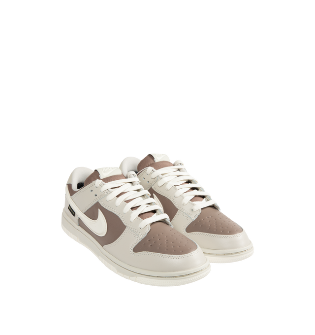 Image 2 of 5 - BROWN - NIKE Dunk Low GORE-TEX Sneaker featuring waterproof GORE-TEX finish, low-cut silhouette, reflective-design detail, padded collar, foam midsole and rubber outsole with classic pivot circle.