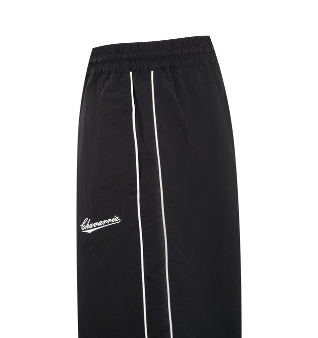 Image 3 of 3 - BLACK - WILLY CHAVARRIA Bad Boy Track Pant featuring a relaxed, easy fit, side pockets, elastic waistband and hems, lightweight, stacked double CHAVARRIA logos at the left pocket and double stripes down legs. 100% nylon.