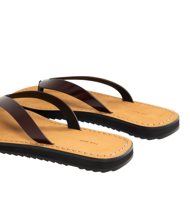 Image 3 of 4 - BROWN - THE ROW City Flip Flop featuring glossy calfskin leather with contrast leather footbed, stitched detailing, and lightly treaded rubber sole. 100% calfskin leather. Made in Italy.