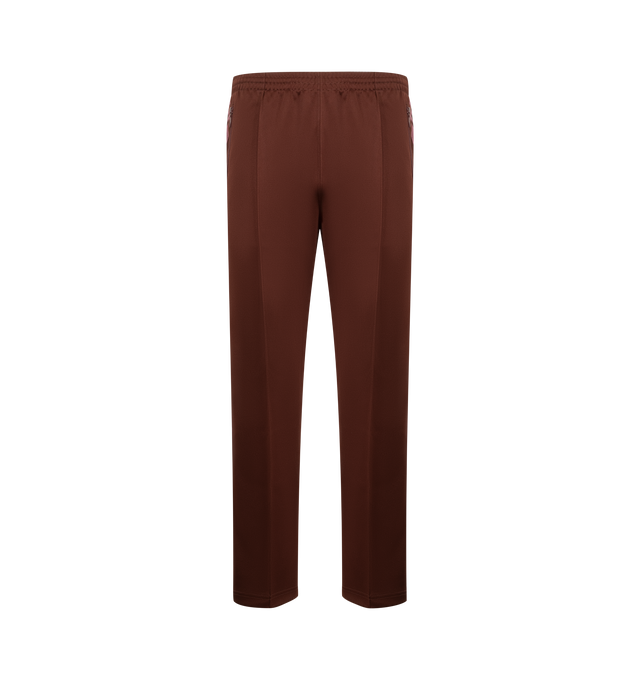 Image 1 of 3 - BROWN - NEEDLES Track Pant featuring signature design details, striped trims, an embroidered butterfly logo, elastic waist with drawstring and zipped pockets. 100% polyester. Made in Japan.