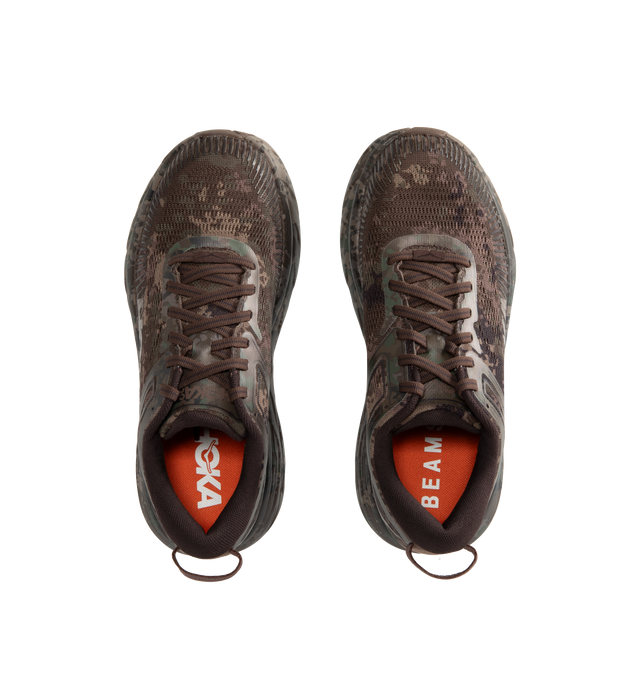 Image 5 of 5 - BROWN - Hoka Unisex Bondi 7 Beams Sneakers reinterpret the ultra-cushioned silhouette with a custom camouflage upper inspired by Japanese Zen gardens. The vegan open-mesh construction features a memory foam collar, TPU overlays, 3D-printed logos, a reflective secondary lace, and a lace keeper. Upper: Vegan Mesh and TPU. *Unisex style in men's sizing.
