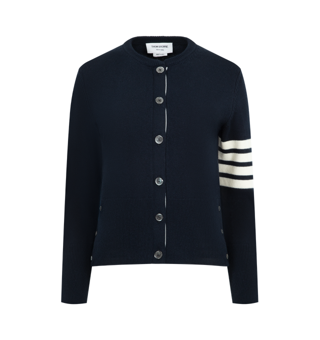 Image 1 of 3 - NAVY - THOM BROWNE Lunar New Year Cardigan featuring crew-neckline, front button closure with RWB grosgrain placket, ribbed neckline, ribbed buttoned cuffs with RWB grosgrain trim, buttoned side vents with RWB grosgrain trim, ribbed hem, 4-bar detailing, signature striped grosgrain loop tab and classic fit. 100% virgin wool. Made in Italy.