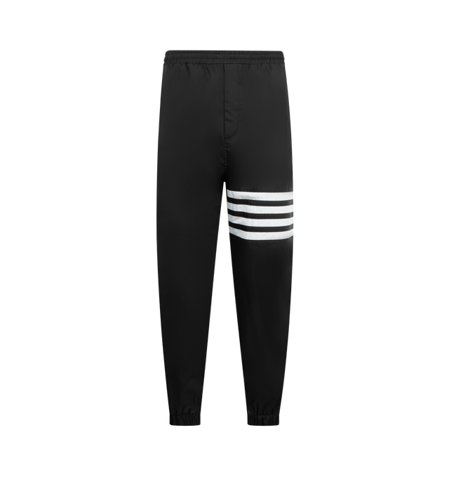 Image 1 of 3 - BLACK - THOM BROWNE Shiny Ripstop 4 Bar Track Pant featuring elasticated waistband with internal drawstring, zip fly, hand pockets and back pocket with hidden zips, elasticated cuffs, mesh lining, 4-bar detailing and signature striped grosgrain loop tab. 81% polyamide, 19% polyester. Made in Italy.