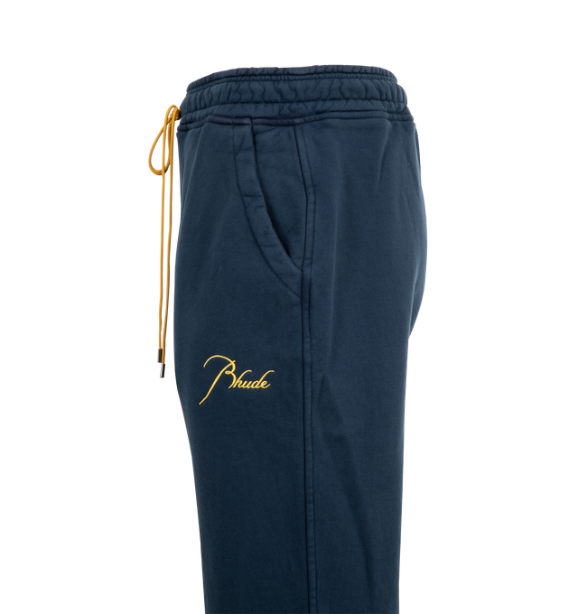 Image 3 of 3 - NAVY - RHUDE Classique Sweatpants featuring heavyweight cotton-blend fleece, drawstring at elasticized waistband, three-pocket styling, logo embroidered at front and gusset at inseam. 98% cotton, 2% polyester. Made in United States.