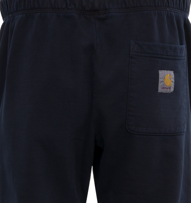 Image 5 of 5 - NAVY - CARHARTT WIP Class of 89 Sweat Pant featuring loose fit, pigment-dyed, adjustable waistband, two side pockets, one rear pocket, graphic print and square Label. 84% cotton, 16% polyester. 