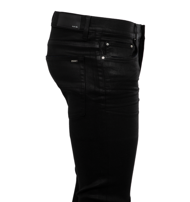 Image 2 of 3 - BLACK - AMIRI Wax Jeans featuring belt loops, five-pocket styling, button-fly, hand-distressed detailing at front, quilted grained leather underlay at legs, leather logo patch at back waistband and logo-engraved silver-tone hardware. 92% cotton, 6% elastomultiester, 2% elastane. Trim: 100% leather. Made in United States. 