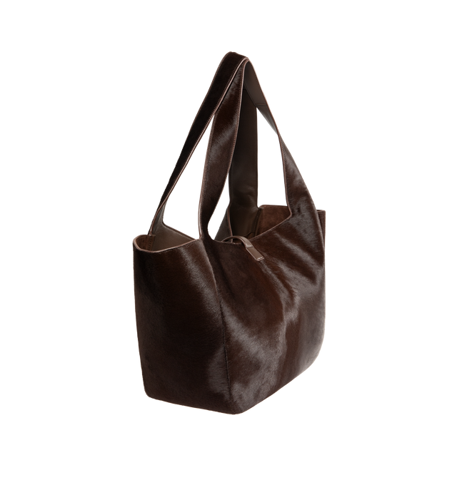 Image 2 of 3 - BROWN - SAINT LAURENT Le 5 7 Bea in pony hair leather featuring lightweight and fully lined in tonal suede, inner zip pocket, leather tab closure, an east/west format, inner ties that allow the sides to be collapsed or expanded and bronze-tone hardware. 19.7" x 11" x 7.1". Calfskin leather. Made in Italy.