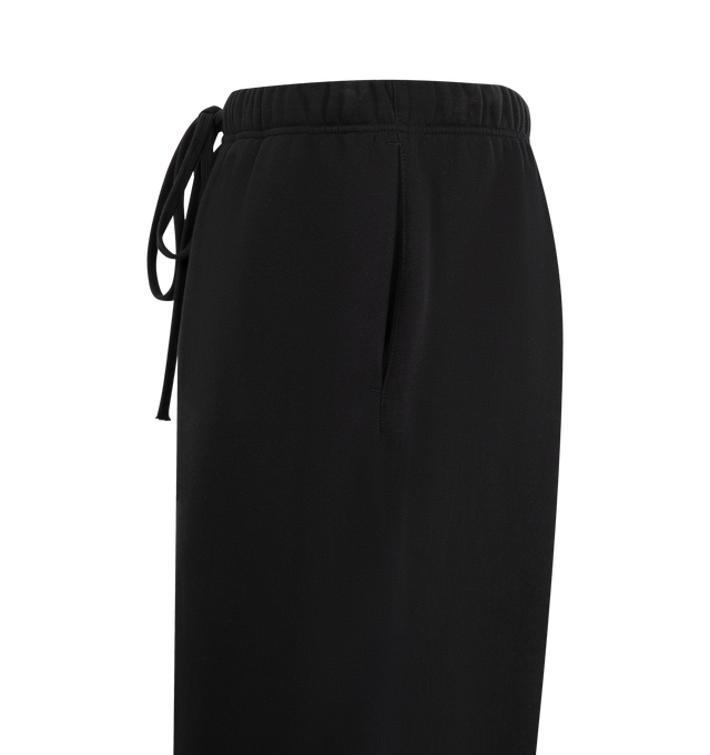 Image 4 of 4 - BLACK - FEAR OF GOD ESSENTIALS Lounge Fleece Sweatpant featuring lounge fit, oversized, voluminous leg and seat, "Essentials" screenprint logo, encased elastic waistband, heavyweight drawstring with rubberized tip, side seam pockets and "Fear of God Essentials" translucent rubberized label. 80% cotton, 20% polyester fleece.