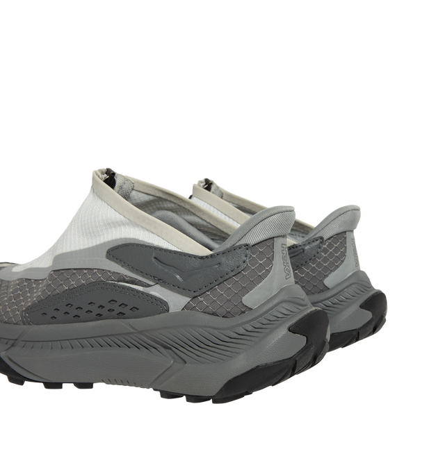 Image 3 of 5 - GREY - Hoka Project Transport Sneakers feature a shrouded ripstop upper with textured synthetic overlays for lightweight durability and a sleek, modern look. Designed for everyday wear, these performance sneakers include a quick-lace system with a zippered shroud, reflective details, signature HOKA cushioning, and a Vibram Ecostep outsole for reliable traction and lasting comfort. Main Material: Ripstop Textile and Synthetic. Sole: Vibram Rubber. Made in Vietnam.