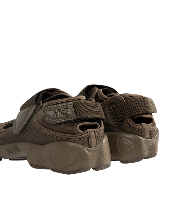 Image 3 of 5 - BROWN - NIKE Air Rift Sneaker featuring hook-and-loop straps on the midfoot and heel, Nike Air unit in the heel combined with plush foam, rubber detailing on the outsole, upper features a blend of elastane, polyester and nylon materials for a flexible fit and split toe design.