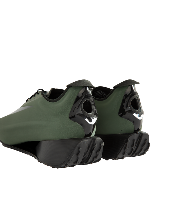 Image 3 of 5 - GREEN - Nike Women's First Sight Noir Sneakers are crafted from a sleek one-piece upper and feature a sculptural silhouette inspired by Nike's running heritage. Designed as the debut style in the First Sight collection, this fashion-forward sneaker is defined by a circular heel cutout, a thick angular foam midsole, and bold branding details that blend athletic performance with modern statement styling. Main Material: Synthetic Upper. Midsole: Soft Foam Cushioning. Closure: Lace-Up. Details: O