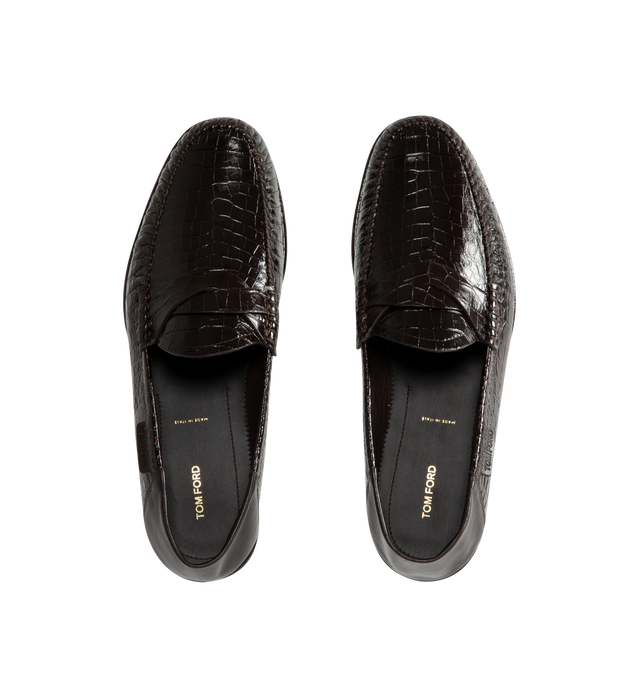 Image 5 of 5 - BROWN - Tom Ford Men's Soft Printed Alligator Sebastian Loafer is crafted from soft printed alligator-effect calf leather and features a distinctive twisted band detail. Designed as a soft loafer with a collapsible back, this versatile style can also be worn as a sabot. The refined silhouette is finished with a leather lining and a durable leather and rubber sole. Main Material: 100% Calf Leather. Lining: 75% Kid Leather, 25% Calf Leather. Sole: 70% Rubber, 30% Calf Leather. Made in Italy.