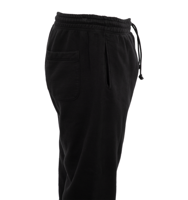 Image 3 of 4 - BLACK - SAINT MICHAEL Logo Sweatpants featuring jersey texture, elasticated waistband, two side welt pockets, logo print to the front, elasticated ankles, rear patch pocket and drawstring waist. 89% cotton, 8% polyester, 3% rayon. 