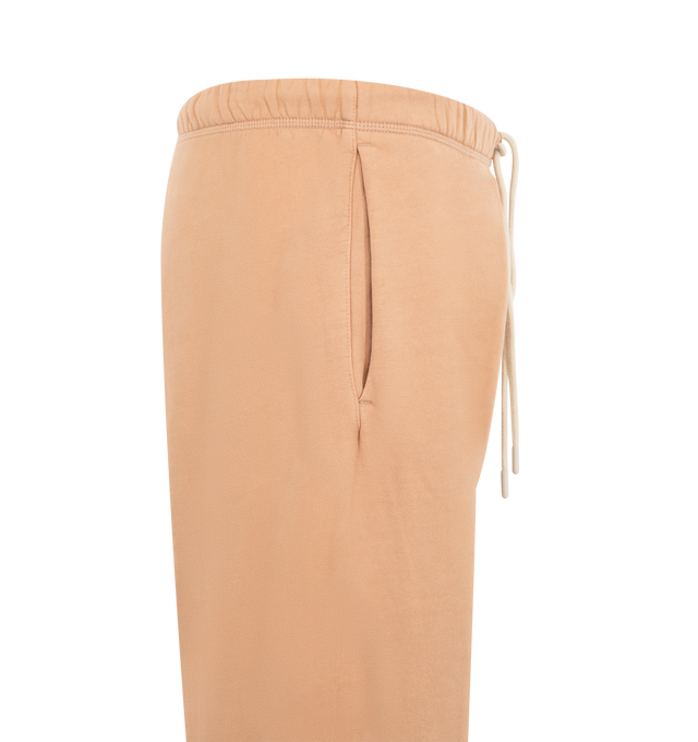 Image 3 of 3 - ORANGE - Fear of God Essentials Mens Classic Sweatshorts are crafted from heavyweight 390 GSM cotton fleece. Feature a classic relaxed fit, elasticized waistband with bungee drawcord, side-seam pockets, pigment-dyed finish, puff-printed F26 graphic, and an Essentials signature label. Main Material: 100% Cotton.
