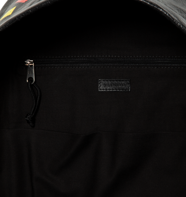 Image 3 of 3 - BLACK - BALENCIAGA Explorer Backpack featuring arena lambskin with printed stickers, one top handle, adjustable shoulder straps, Balenciaga logo debossed and printed at front, matte black hardware, top double-ended zip-fastening closure, front zipped pocket, 1 inner zipped pocket, 1 inner patch pocket, BB logo engraved zipper puller with cotton string and cotton canvas lining. L13.7 x H18.5 x W7.8 inch. Lambskin, calfskin, polyester, polyamide. Made in Italy.