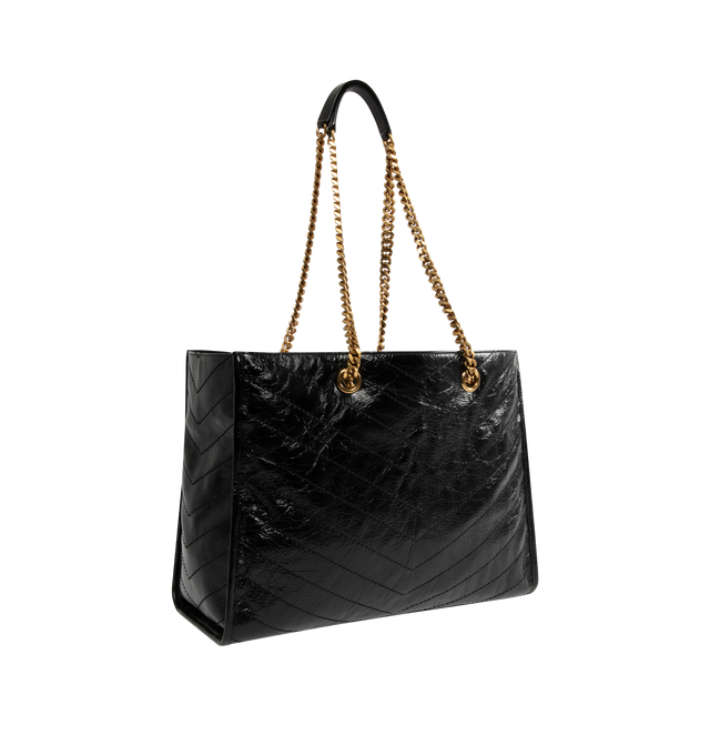 Image 2 of 3 - BLACK - SAINT LAURENT Niki Shopping Bag in vintage leather featuring vintage calfskin, chevron topstitching, cotton lining, bronze-tone hardware, magnetic snap-button closure and one zip pocket. 13" x 10.6" x 5.5". Strap drop: 10.6". Calfskin. Made in Italy.