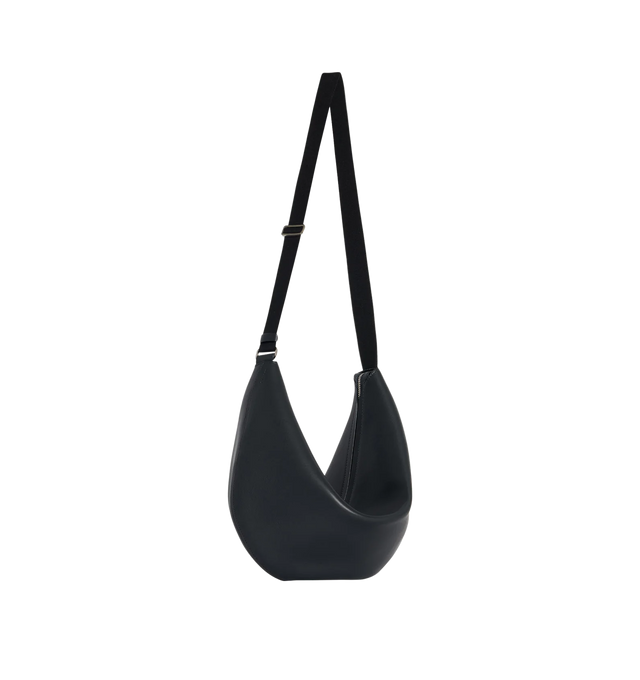 Image 2 of 3 - BLACK - THE ROW Crossbody Crescent Bag featuring crescent-shaped crossbody bag in textured calfskin leather with single seam construction, adjustable woven shoulder strap and zipper closure. 100% calfskin leather. Lined in 100% lambskin leather. Made in Italy.