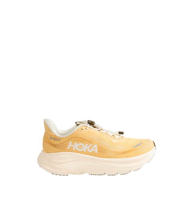 Image 1 of 5 - ORANGE - Hoka Women's Clifton 11 GTX Running Sneakers feature a closed-mesh upper with a GORE-TEX Invisible Fit membrane and PFC-free water-repellent treatment. An adjustable speed-lace system with toggle, reflective details, a compression-molded EVA midsole, and a Durabrasion rubber outsole with forefoot traction pods complete the weather-ready design. Upper: Mesh with GORE-TEX Membrane. Midsole: EVA Foam. Sole: Rubber. Heel-to-Toe Drop: 8 mm.