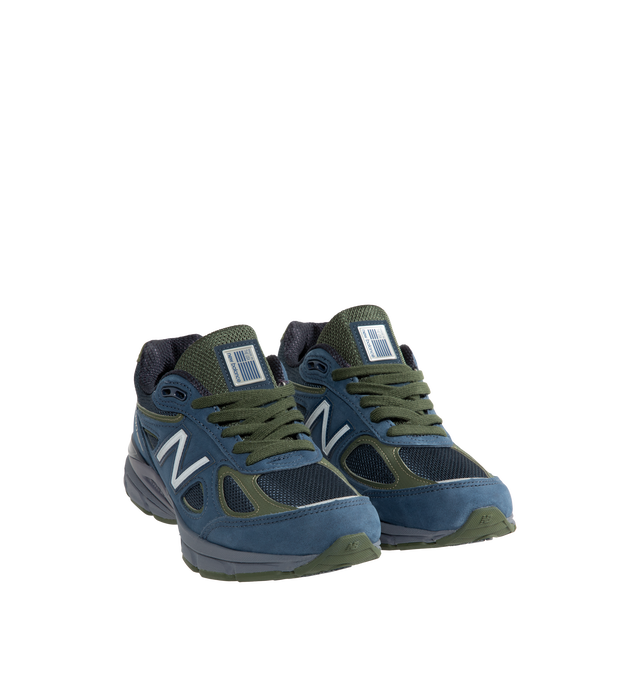 Image 2 of 5 - NAVY - New Balance Unisex Made in USA 990v4 Sneakers feature the iconic silhouette that has defined premium running-inspired footwear since its debut in 1982. Originally introduced in 2016, the 990v4 further refined the modernization of the classic design with a premium combination of mesh, nubuck leather, and synthetic overlays. Finished in a versatile grey and navy color palette, this Made in USA edition is equipped with ENCAP midsole cushioning that combines lightweight foam with a durable