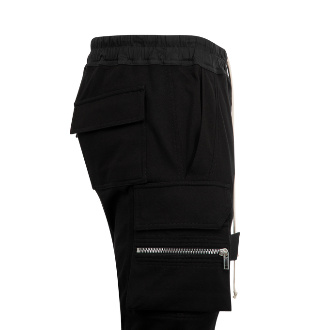 Image 3 of 3 - BLACK - RICK OWENS Mastadon Cargo Pants featuring slim-fit, stretch GOTS-certified organic cotton, drawstring at elasticized waistband, four-pocket styling, button fly, pen slots at front, elasticized cuffs and cargo and zip pocket at outseams. 97% cotton, 3% elastane. Made in Italy.