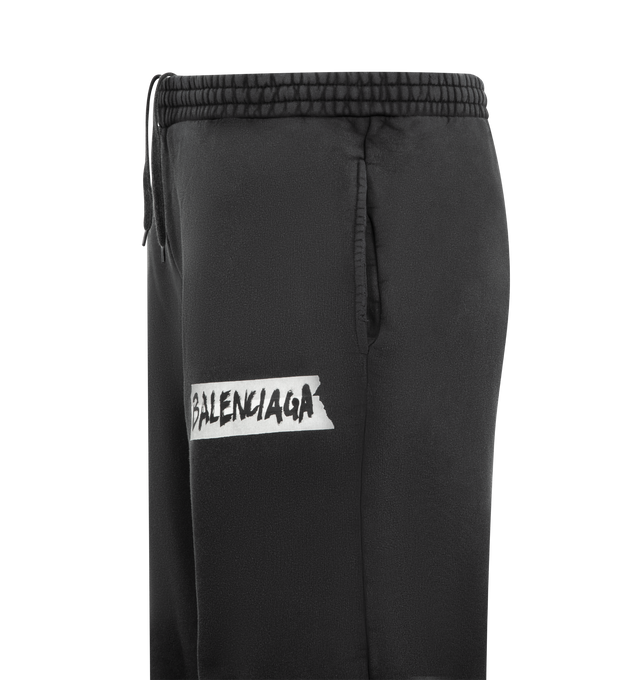 Image 3 of 3 - BLACK - BALENCIAGA Masking Tape Baggy Pants featuring heavy fleece, mid-waist, elasticated waistband, 2 slash pockets and masking tape artwork on left leg. 100% cotton. Made in Portugal.